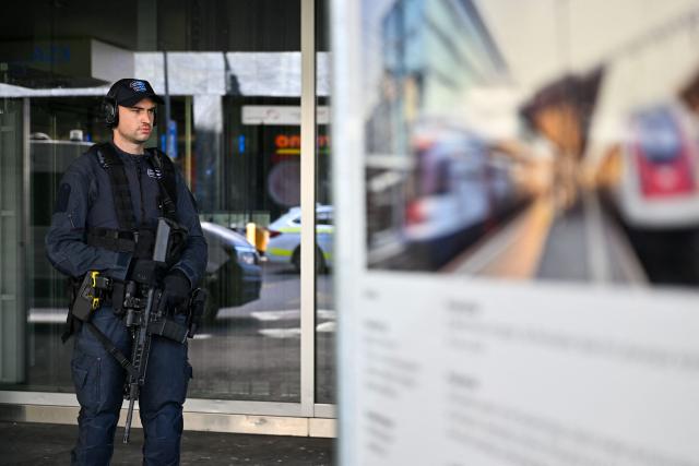 A police officer stands near Aarau railway station following a shooting at a rave in Aarau, northern Switzerland, on 30 August 2026. One person was killed and five others were wounded, some of them seriously, in a shooting at a rave party in northern Switzerland, local police said. (Photo by Harold CUNNINGHAM / AFP)