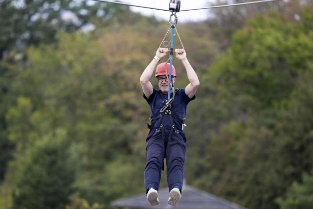 President of Belgium's Partie Socialiste Paul Magnette rides on a zip line during a 'family day' at  Adventure Valley in Durbuy on August 30, 2026. (Photo by NICOLAS MAETERLINCK / Belga / AFP) / Belgium OUT
