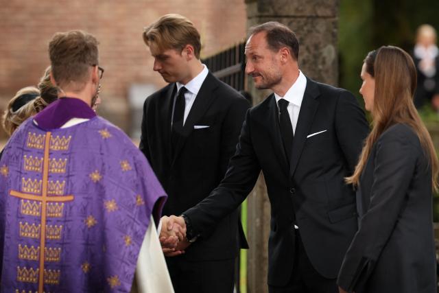 Norway's King Haakon VIII (2ndR) shakes hands with parish priest Ida Buen Hanevold, as Dean Oyvind Stabrun (L), Prince Sverre Magnus (2ndL) and Crown Princess Ingrid Alexandra (R) look on, after attending a memorial church service for the late King Harald V at Asker Church in Asker, Norway, on August 30, 2026. King Harald V of Norway, who died on August 28, 2026 aged 89, remained a unifying figure in his country until the very end, a pillar of stability amid a string of family scandals that tarnished the final years of his reign. (Photo by Odd ANDERSEN / AFP)