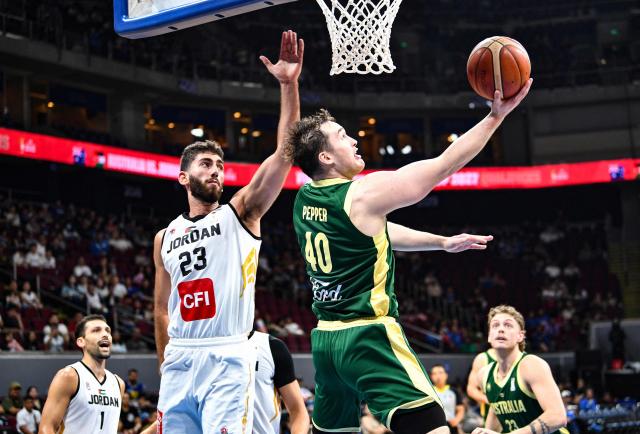 Australia's Elijah Pepper (R) lays up against Jordan's Mohammad Shaher during their 2027 FIBA Basketball World Cup Asian qualifier group E match at the Mall of Asia Arena in Pasay city, Metro Manila on August 30, 2026. (Photo by Ted ALJIBE / AFP)