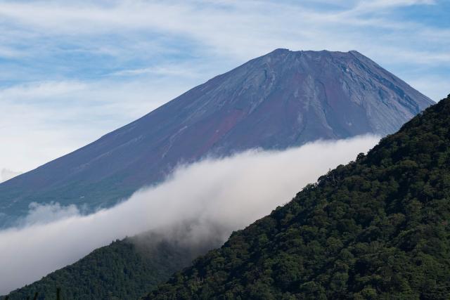 Mt. Fuji is seen behind a smaller mountain on lake Motosu in Minobu, Yamanashi Prefecture on August 30, 2026. (Photo by Andrew CABALLERO-REYNOLDS / AFP)