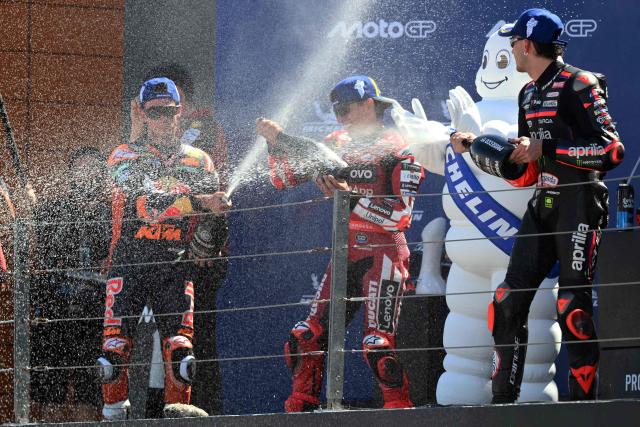 (From L) Team Red Bull KTM Factory Racing's Pedro Acosta, Team Ducati Lenovo Team's Marc Marquez and Team Aprilia Racing's Marco Bezzecchi celebrate on the podium after the MotoGP race of the Aragon MotoGP Grand Prix at the Motorland circuit in Alcaniz, northeastern Spain, on August 30, 2026. (Photo by JOSE JORDAN / AFP)