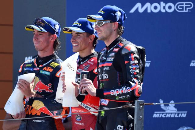 (From L) Team Red Bull KTM Factory Racing's Pedro Acosta, Team Ducati Lenovo Team's Marc Marquez and Team Aprilia Racing's Marco Bezzecchi celebrate on the podium after the MotoGP race of the Aragon MotoGP Grand Prix at the Motorland circuit in Alcaniz, northeastern Spain, on August 30, 2026. (Photo by JOSE JORDAN / AFP)