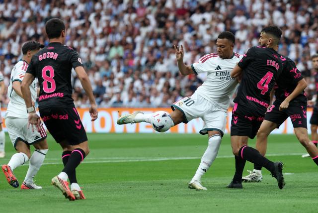 Real Madrid's French forward #10 Kylian Mbappe and Malaga's Spanish defender #04 Einar Galilea fight for the ball during the Spanish league football match between Real Madrid CF and Malaga CF at Santiago Bernabeu Stadium in Madrid on August 30, 2026. (Photo by Thomas COEX / AFP)