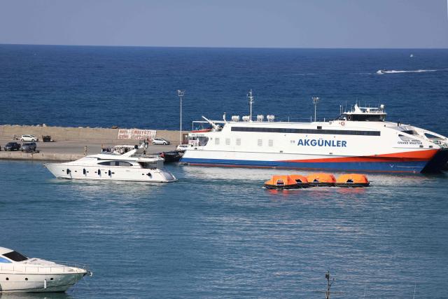 Rescue rafts are towed into the port of Kyrenia in the self-proclaimed Turkish Republic of Northern Cyprus (TRNC), recognised only by Turkey, in the north of the divided Mediterranean island of Cyprus on August 30, 2026, during search and rescue operations following a ferry capsizing. A passenger ferry capsized and sank off Northern Cyprus on August 30, killing at least seven people and leaving 23 missing, officials said, as a rescue operation was under way. The cause was not yet established. The vessel capsized 6.5 kilometres (four miles) off the coast of Cyprus, shortly after it had left a Northern Cyprus port heading to Turkey's mainland. (Photo by Birol BEBEK / AFP)
