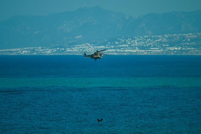 A Turkish helicopter searches the waters during a rescue operation off the coast of Kyrenia, in the self-proclaimed Turkish Republic of Northern Cyprus (TRNC), recognised only by Turkey, on August 30, 2026, after a ferry capsized. A passenger ferry capsized and sank off Northern Cyprus on August 30, killing at least seven people and leaving 23 missing, officials said, as a rescue operation was under way. The cause was not yet established. But one rescued passenger told local media a blast went off at the bow of the ferry before it rolled over. (Photo by Jewel SAMAD / AFP)