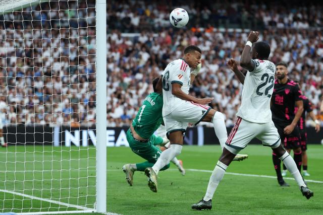 Malaga's Spanish goalkeeper #01 Alfonso Herrero and Real Madrid's French forward #10 Kylian Mbappe fight for the balk during the Spanish league football match between Real Madrid CF and Malaga CF at Santiago Bernabeu Stadium in Madrid on August 30, 2026. (Photo by Thomas COEX / AFP)