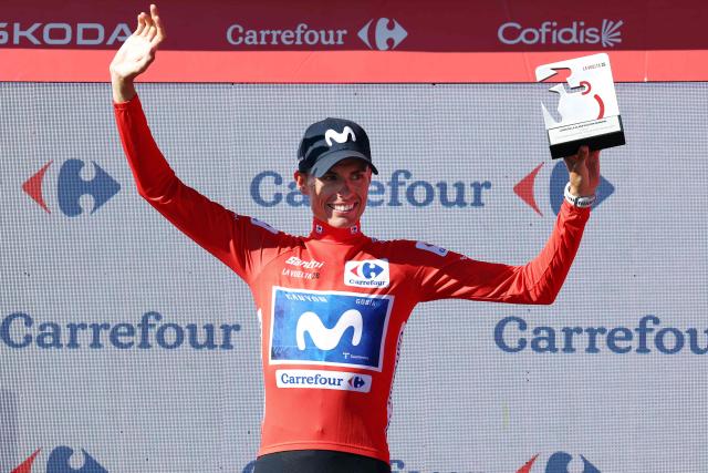Team Movistar's Spanish rider Enric Mas celebrates on the podium retaining the overall leader's red jersey after winning the 9th stage of the Vuelta a Espana 2026 cycling tour, a 187,4 km race between Villajoyosa and Alto de Aitana in Confrides, on August 30, 2026. (Photo by Josep LAGO / AFP)