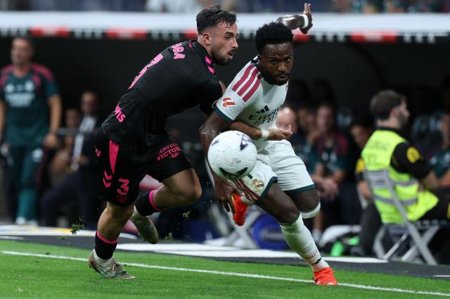 Malaga's Spanish defender #03 Carlos Puga and Real Madrid's Brazilian forward #07 Vinicius Junior fight for the ball during the Spanish league football match between Real Madrid CF and Malaga CF at Santiago Bernabeu Stadium in Madrid on August 30, 2026. (Photo by Thomas COEX / AFP)