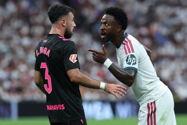 Malaga's Spanish defender #03 Carlos Puga argues with Real Madrid's Brazilian forward #07 Vinicius Junior during the Spanish league football match between Real Madrid CF and Malaga CF at Santiago Bernabeu Stadium in Madrid on August 30, 2026. (Photo by Thomas COEX / AFP)