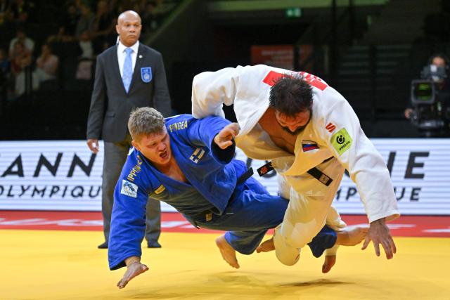 Russia's Inal Tasoev (white) and Finland's Martti Puumalainen compete in the men's above 100kg gold medal bout at the Lausanne Grand Slam judo tournament, part of the IJF World Judo Tour, in Prilly on August 30, 2026. (Photo by Fabrice COFFRINI / AFP)