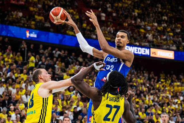 Sweden's small forward #18 Viktor Gaddefors, France's power forward #32 Victor Wembanyama and Sweden's power forward #27 Zaba Bangala vie during the FIBA 2027 World Cup qualifying basketball match, 2nd round Group L, between Sweden and France at Avicii Arena in Stockholm, on August 30, 2026. (Photo by Jonathan NACKSTRAND / AFP)