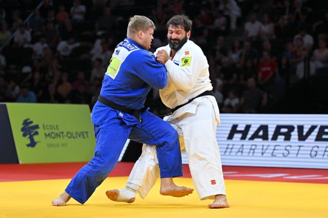 Russia's Inal Tasoev (white) shakes hand to Finland's Martti Puumalainen after winning in the men's above 100kg gold medal bout at the Lausanne Grand Slam judo tournament, part of the IJF World Judo Tour, in Prilly on August 30, 2026. (Photo by Fabrice COFFRINI / AFP)
