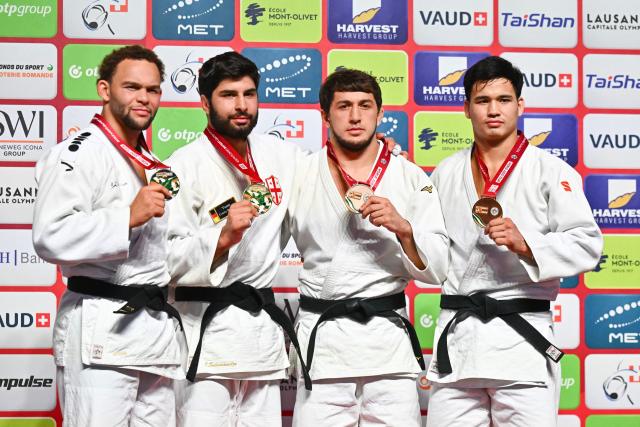 (From L) Silver medallist Netherlands' Simeon Catharina, gold medallist Georgia's Ilia Sulamanidze, bronze medallists Bahrain's Said Sadrudinov and Uzbekistan's Ernazar Sarsenbaev pose during the podium ceremony of the men's under 100kg category final event at the Lausanne Grand Slam judo tournament, part of the IJF World Judo Tour, in Prilly on August 30, 2026. (Photo by Fabrice COFFRINI / AFP)
