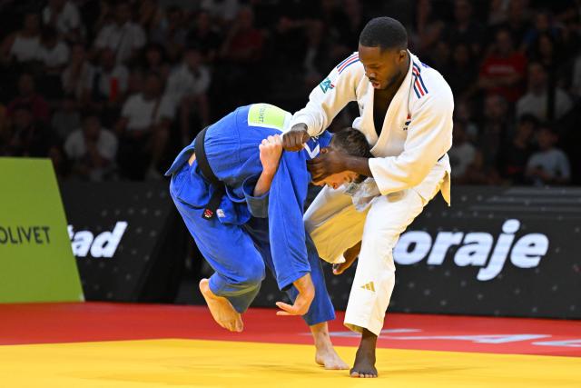 France's Maxime-Gael Ngayap Hambou (white) and Russia’s Egor Andoni compete in the men's under 90kg bronze medal bout at the Lausanne Grand Slam judo tournament, part of the IJF World Judo Tour, in Prilly on August 30, 2026.  (Photo by Fabrice COFFRINI / AFP)