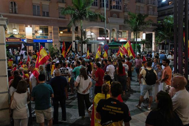 Residents carrying Spanish flaks take part in a proetst to demand solutions from the government so that the city can return to normal, in the North African Spanish city of Ceuta, on August 30, 2026. Tensions have been high in the territory of 80,000 inhabitants since tens of thousands of people crossed into Ceuta from Morocco over several days in July, triggering a Europe-wide migrant alert. (Photo by Antonio Sempere / AFP)