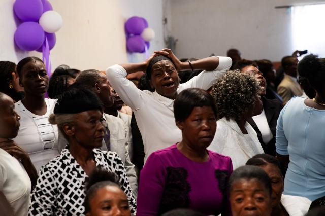People attend a collective funeral service for more than twenty people killed by armed gangs last week in Kenscoff, a neighborhood near Port-au-Prince, on August 30, 2026. Gang members attacked displaced people huddling inside a church near Haiti's capital, killing around 40, some of them execution-style, the mayor told AFP on August 24. (Photo by Clarens SIFFROY / AFP)