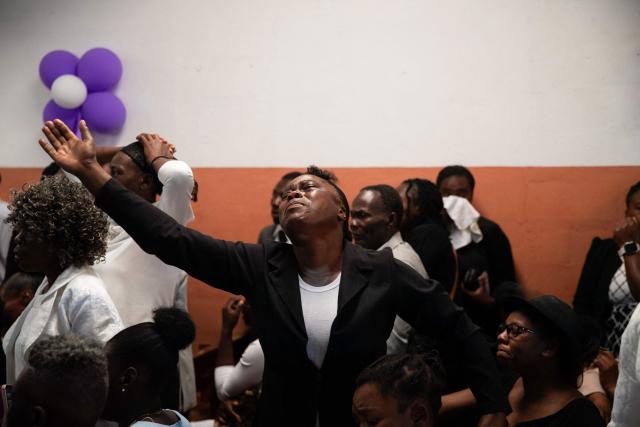 People attend a collective funeral service for more than twenty people killed by armed gangs last week in Kenscoff, a neighborhood near Port-au-Prince, on August 30, 2026. Gang members attacked displaced people huddling inside a church near Haiti's capital, killing around 40, some of them execution-style, the mayor told AFP on August 24. (Photo by Clarens SIFFROY / AFP)