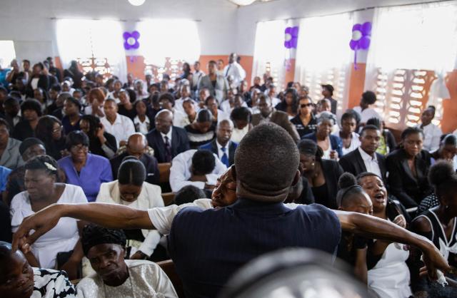 A man reacts during a collective funeral service for more than twenty people killed by armed gangs last week in Kenscoff, a neighborhood near Port-au-Prince, on August 30, 2026. Gang members attacked displaced people huddling inside a church near Haiti's capital, killing around 40, some of them execution-style, the mayor told AFP on August 24. (Photo by Clarens SIFFROY / AFP)