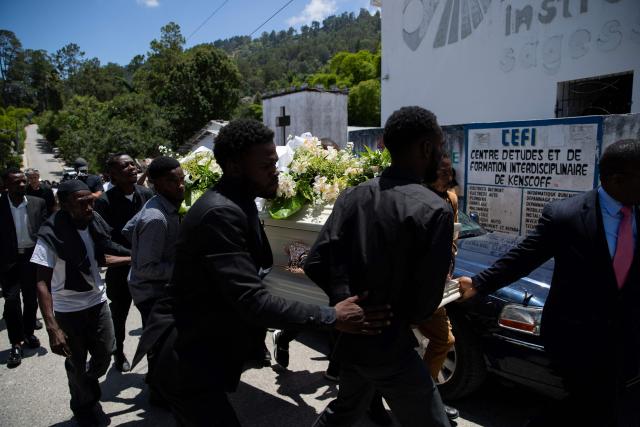 A coffin is carried to a hearse during a collective funeral service for more than twenty people killed by armed gangs last week in Kenscoff, a neighborhood near Port-au-Prince, on August 30, 2026. Gang members attacked displaced people huddling inside a church near Haiti's capital, killing around 40, some of them execution-style, the mayor told AFP on August 24. (Photo by Clarens SIFFROY / AFP)