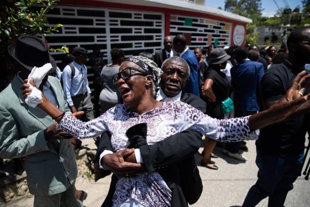 A woman reacts during a collective funeral service for more than twenty people killed by armed gangs last week in Kenscoff, a neighborhood near Port-au-Prince, on August 30, 2026. Gang members attacked displaced people huddling inside a church near Haiti's capital, killing around 40, some of them execution-style, the mayor told AFP on August 24. (Photo by Clarens SIFFROY / AFP)