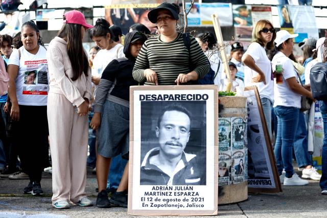 A woman holds a picture of a missing man during a demonstration to mark the International Day of the Victims of Enforced Disappearances in Guadalajara, Jalisco state, Mexico on August 30, 2026. (Photo by ULISES RUIZ / AFP)