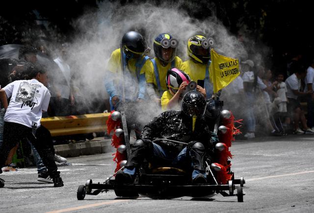 Revelers compete in a downhill makeshift car fun race during the "Festival de Descenso y Adrenalina" in Medellin, Colombia on August 30, 2026. (Photo by JAIME SALDARRIAGA / AFP)