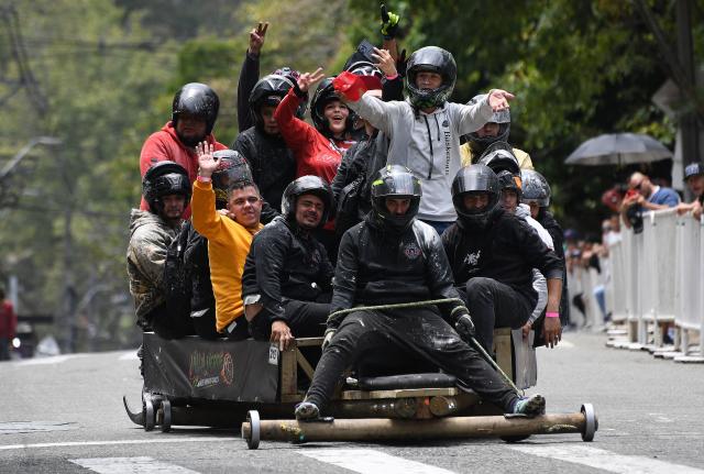 Revelers compete in a downhill makeshift car fun race during the "Festival de Descenso y Adrenalina" in Medellin, Colombia on August 30, 2026. (Photo by JAIME SALDARRIAGA / AFP)