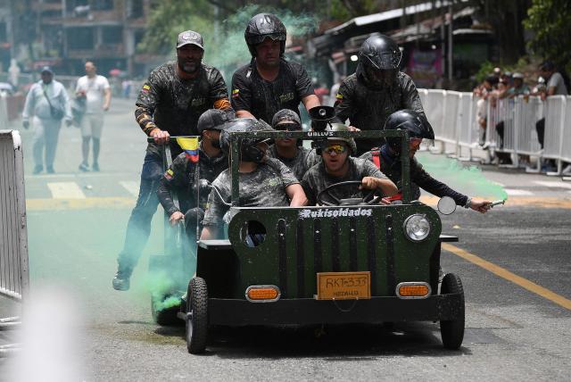 Revelers compete in a downhill makeshift car fun race during the "Festival de Descenso y Adrenalina" in Medellin, Colombia on August 30, 2026. (Photo by JAIME SALDARRIAGA / AFP)