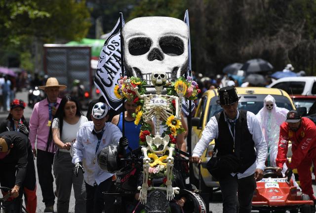 Revelers prepare to compete in a downhill makeshift car fun race during the "Festival de Descenso y Adrenalina" in Medellin, Colombia on August 30, 2026. (Photo by JAIME SALDARRIAGA / AFP)