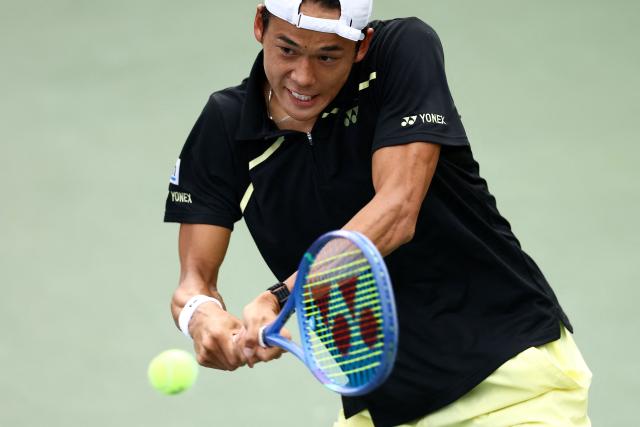 Japan's Rei Sakamoto hits a return to Australia's Aleksandar Vukic during their men's singles first round tennis match on day one of the US Open tennis tournament at the USTA Billie Jean King National Tennis Center in New York on August 30, 2026. (Photo by CHARLY TRIBALLEAU / AFP)