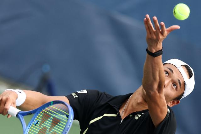 Japan's Rei Sakamoto serves to Australia's Aleksandar Vukic during their men's singles first round tennis match on day one of the US Open tennis tournament at the USTA Billie Jean King National Tennis Center in New York on August 30, 2026. (Photo by CHARLY TRIBALLEAU / AFP)