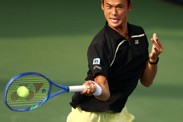 Japan's Rei Sakamoto hits a return to Australia's Aleksandar Vukic during their men's singles first round tennis match on day one of the US Open tennis tournament at the USTA Billie Jean King National Tennis Center in New York on August 30, 2026. (Photo by CHARLY TRIBALLEAU / AFP)