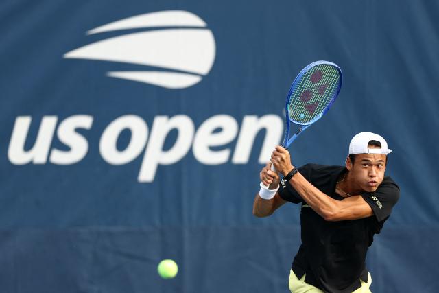 Japan's Rei Sakamoto serves to Australia's Aleksandar Vukic during their men's singles first round tennis match on day one of the US Open tennis tournament at the USTA Billie Jean King National Tennis Center in New York on August 30, 2026. (Photo by CHARLY TRIBALLEAU / AFP)