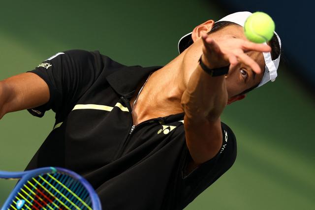 Japan's Rei Sakamoto serves to Australia's Aleksandar Vukic during their men's singles first round tennis match on day one of the US Open tennis tournament at the USTA Billie Jean King National Tennis Center in New York on August 30, 2026. (Photo by CHARLY TRIBALLEAU / AFP)