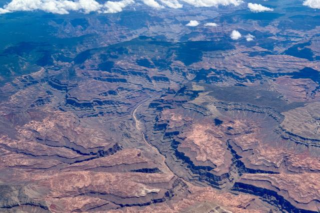 (FILES) File photo shows an aerial view taken on July 7, 2025  of the general area of the Grand Canyon in Arizona, including several bends of the Colorado River. More than 20 people may be missing after a flash flood in Grand Canyon National Park, the National Park Service said in a statement on August 30, 2026. The floods hit the Bright Angel Canyon and Phantom Ranch area on August 29th, the service said, adding that it was working with Arizona authorities to evacuate people and account for individuals in the affected area. (Photo by Daniel SLIM / AFP)