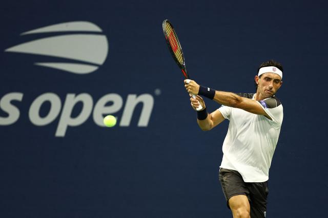 Argentina's Thiago Agustin Tirante hits a backhand against France's Adrian Mannarino during the men's singles first round tennis match on day one of the US Open tennis tournament at the USTA Billie Jean King National Tennis Center in New York City on August 30, 2026. (Photo by CHARLY TRIBALLEAU / AFP)