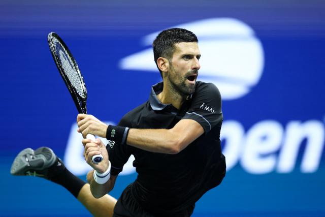 Serbia's Novak Djokovic hits a backhand against Argentina's Mariano Navone during the men's singles first round tennis match on day one of the US Open tennis tournament at the USTA Billie Jean King National Tennis Center in New York City on August 30, 2026. (Photo by CHARLY TRIBALLEAU / AFP)