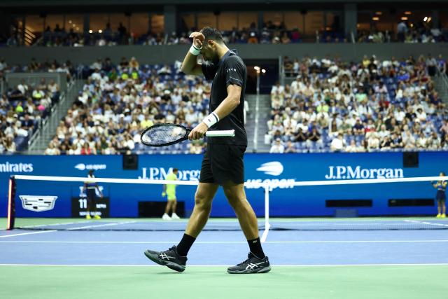 Serbia's Novak Djokovic wipes sweat off his forehead during a match against Argentina's Mariano Navone during the men's singles first round tennis match on day one of the US Open tennis tournament at the USTA Billie Jean King National Tennis Center in New York City on August 30, 2026. (Photo by CHARLY TRIBALLEAU / AFP)