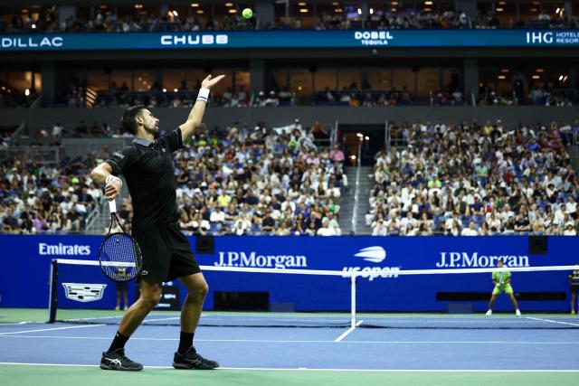 Serbia's Novak Djokovic serves against Argentina's Mariano Navone during the men's singles first round tennis match on day one of the US Open tennis tournament at the USTA Billie Jean King National Tennis Center in New York City on August 30, 2026. (Photo by CHARLY TRIBALLEAU / AFP)