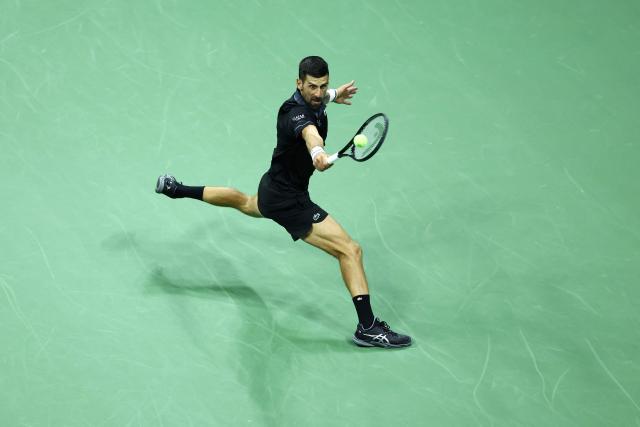 Serbia's Novak Djokovic hits a backhand against Argentina's Mariano Navone during the men's singles first round tennis match on day one of the US Open tennis tournament at the USTA Billie Jean King National Tennis Center in New York City on August 30, 2026. (Photo by CHARLY TRIBALLEAU / AFP)