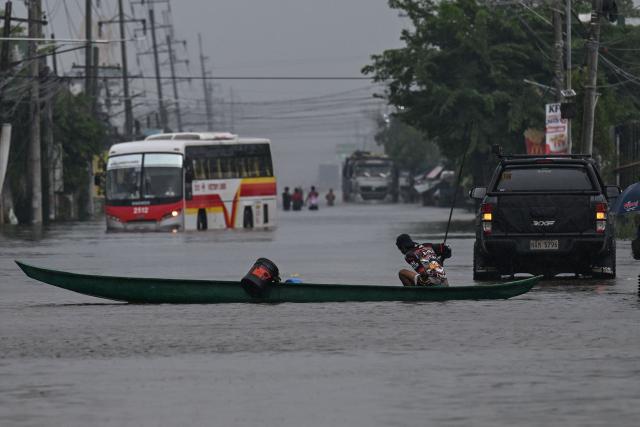 Motorists commute through a flooded street due to rains brought by the southwest monsoon in Pampanga on August 31, 2026. (Photo by Jam STA ROSA / AFP)