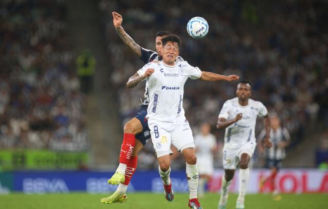 Monterrey's forward #27 Roberto de la Rosa and San Luis' defender #31 Eduardo Aguila fight for the ball during the Liga MX Apertura tournament football match between Monterrey and San Luis, at BBVA stadium in Guadalupe, state of Nuevo Leon, Mexico on August 30, 2026. (Photo by Julio Cesar AGUILAR / AFP)