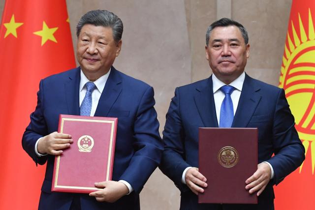 Kyrgyzstan's President Sadyr Japarov and China's President Xi Jinping pose during a signing ceremony following their talks in Bishkek on August 31, 2026. (Photo by Vyacheslav OSELEDKO / AFP)