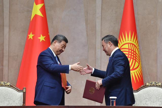 Kyrgyzstan's President Sadyr Japarov and China's President Xi Jinping shake hands during a signing ceremony following their talks in Bishkek on August 31, 2026. (Photo by Vyacheslav OSELEDKO / AFP)