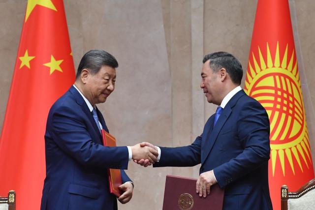 Kyrgyzstan's President Sadyr Japarov and China's President Xi Jinping shake hands during a signing ceremony following their talks in Bishkek on August 31, 2026. (Photo by Vyacheslav OSELEDKO / AFP)