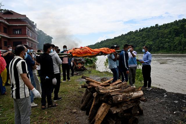 Mourners cremate the body of deceased victim Ayush Khadka, after flash floods in Nepal's Chitwan district on August 31, 2026. Nepal was burying on August 31 some of the hundreds of bodies retrieved after a deadly, tsunami-like flood crashed through the Himalayan region, sweeping away villages and leaving thousands still missing. Distraught families have packed rescue stations and hospitals in search of their missing relatives, while others have faced the grim task of identifying bodies at overflowing morgues. (Photo by Prakash MATHEMA / AFP)