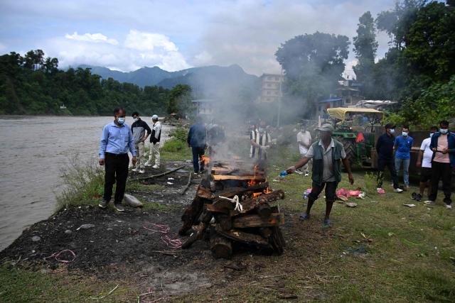 Mourners cremate the body of deceased victim Ayush Khadka, after flash floods in Nepal's Chitwan district on August 31, 2026. Nepal was burying on August 31 some of the hundreds of bodies retrieved after a deadly, tsunami-like flood crashed through the Himalayan region, sweeping away villages and leaving thousands still missing. Distraught families have packed rescue stations and hospitals in search of their missing relatives, while others have faced the grim task of identifying bodies at overflowing morgues. (Photo by PRAKASH MATHEMA / AFP)