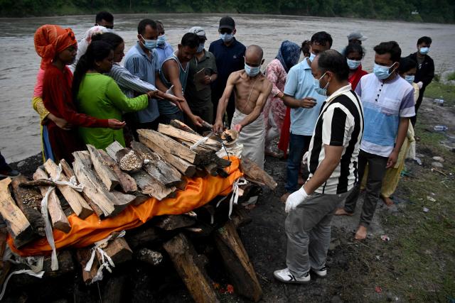 Mourners cremate the body of deceased victim Ayush Khadka, after flash floods in Nepal's Chitwan district on August 31, 2026. Nepal was burying on August 31 some of the hundreds of bodies retrieved after a deadly, tsunami-like flood crashed through the Himalayan region, sweeping away villages and leaving thousands still missing. Distraught families have packed rescue stations and hospitals in search of their missing relatives, while others have faced the grim task of identifying bodies at overflowing morgues. (Photo by PRAKASH MATHEMA / AFP)