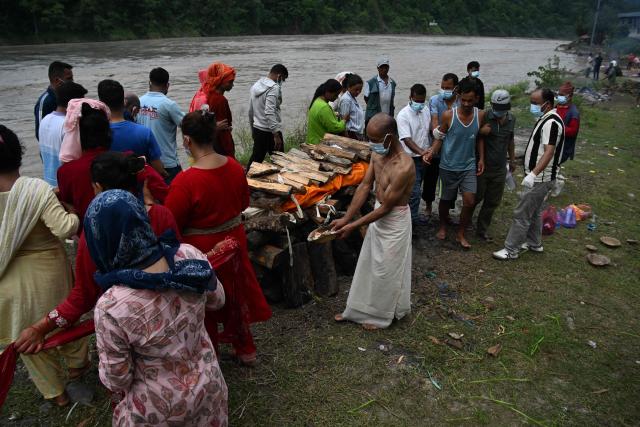 Mourners cremate the body of deceased victim Ayush Khadka, after flash floods in Nepal's Chitwan district on August 31, 2026. Nepal was burying on August 31 some of the hundreds of bodies retrieved after a deadly, tsunami-like flood crashed through the Himalayan region, sweeping away villages and leaving thousands still missing. Distraught families have packed rescue stations and hospitals in search of their missing relatives, while others have faced the grim task of identifying bodies at overflowing morgues. (Photo by PRAKASH MATHEMA / AFP)